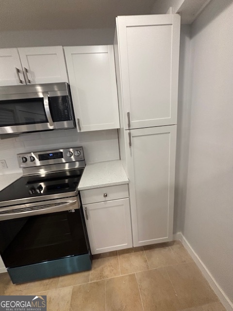 3260 Valley Bend Road South Fulton, GA 30349 - Photo 5 of 23 a kitchen with a stove and a microwave