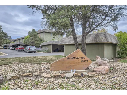 a view of a house with a tree in front of it
