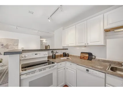 a kitchen with appliances cabinets and a sink