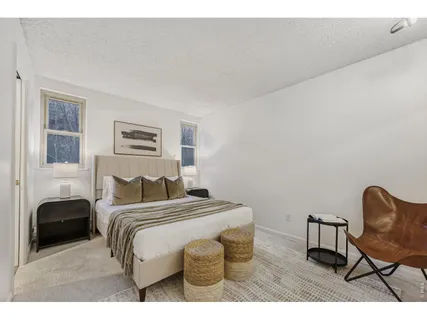 a bedroom with a bed a table and chair