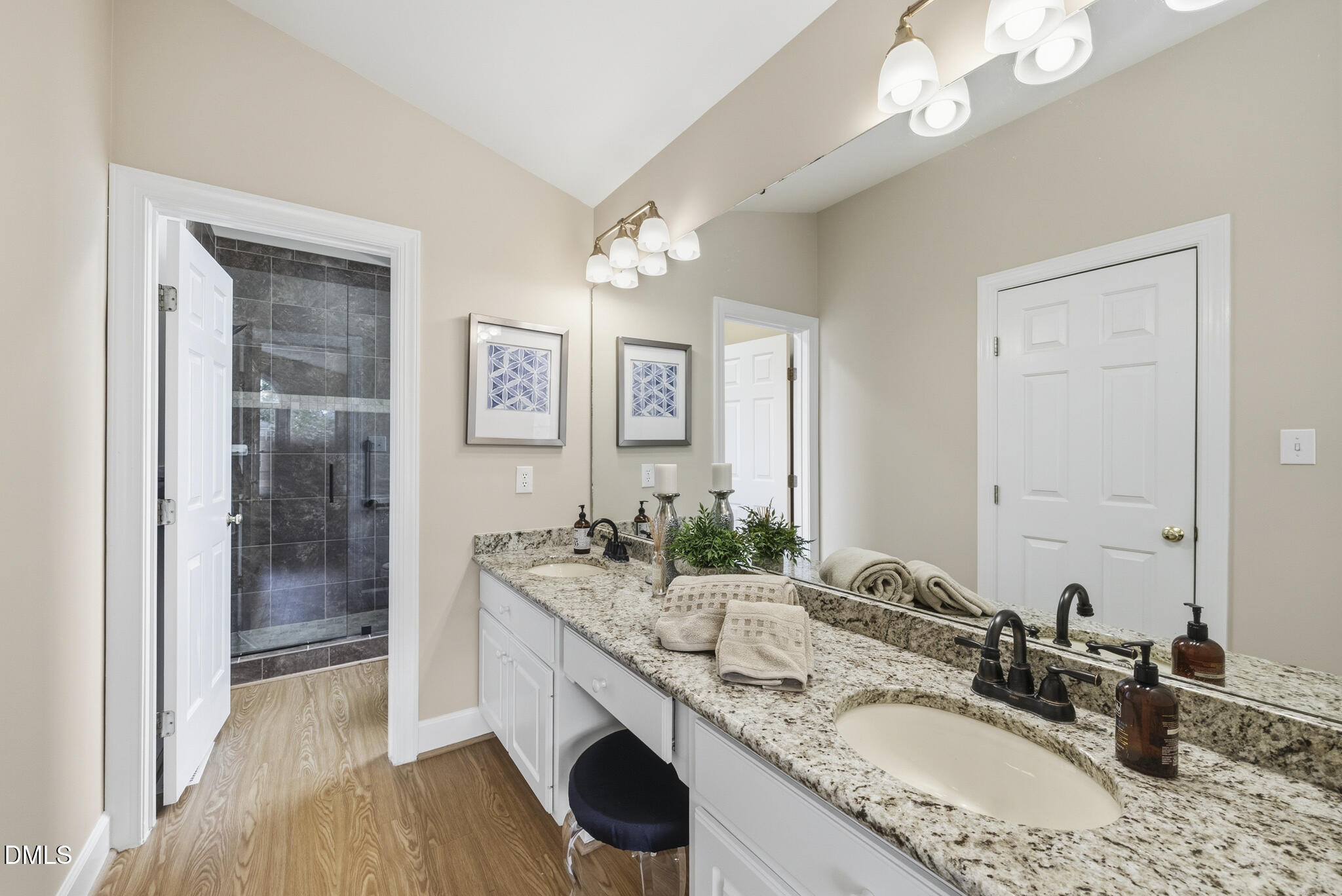 1944 Talamore Court Raleigh, NC 27604 - Photo 17 of 30 a bathroom with a granite countertop double vanity sink a mirror and a shower