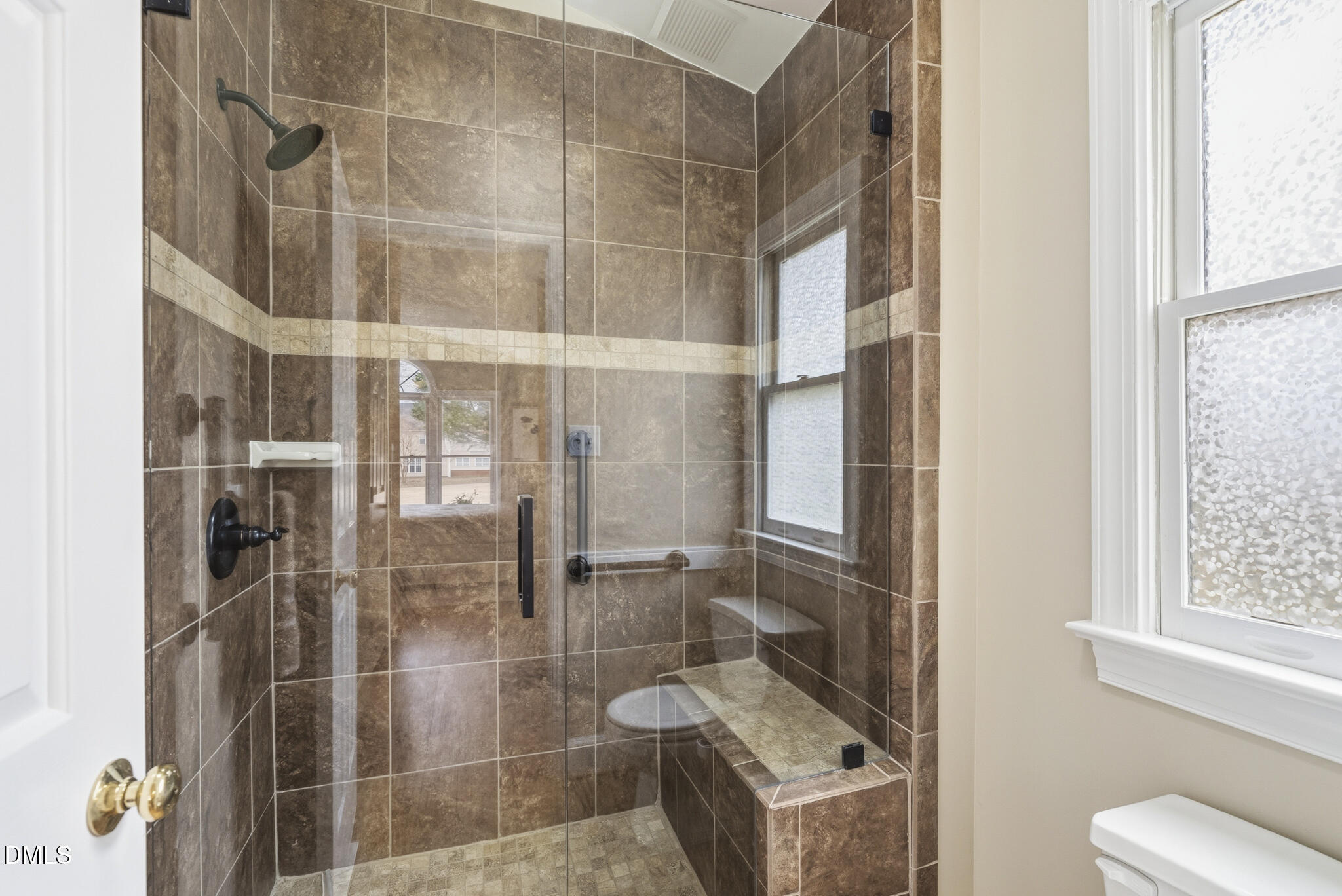 1944 Talamore Court Raleigh, NC 27604 - Photo 18 of 30 a bathroom with a glass shower door