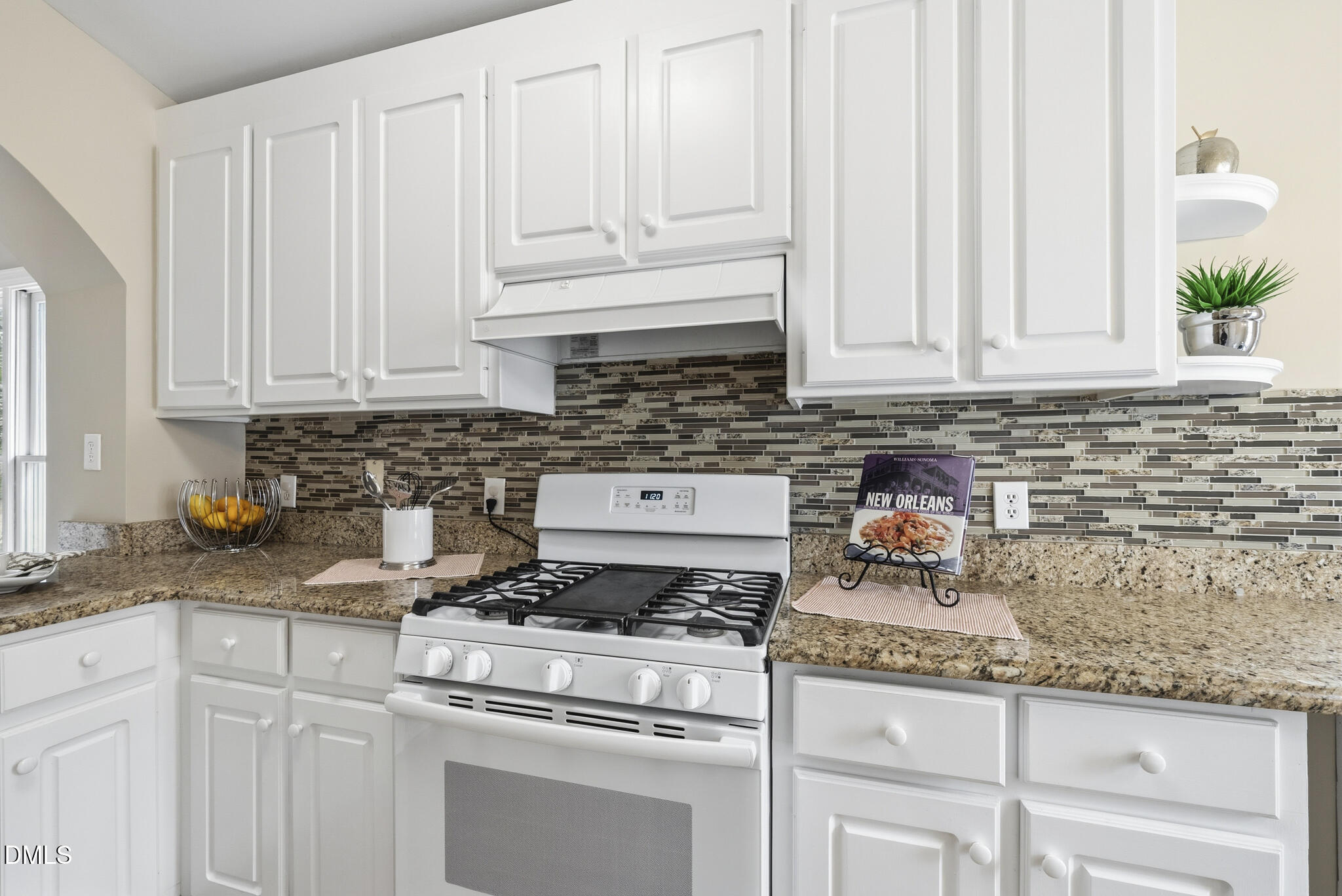 1944 Talamore Court Raleigh, NC 27604 - Photo 5 of 30 a kitchen with granite countertop white cabinets and white appliances