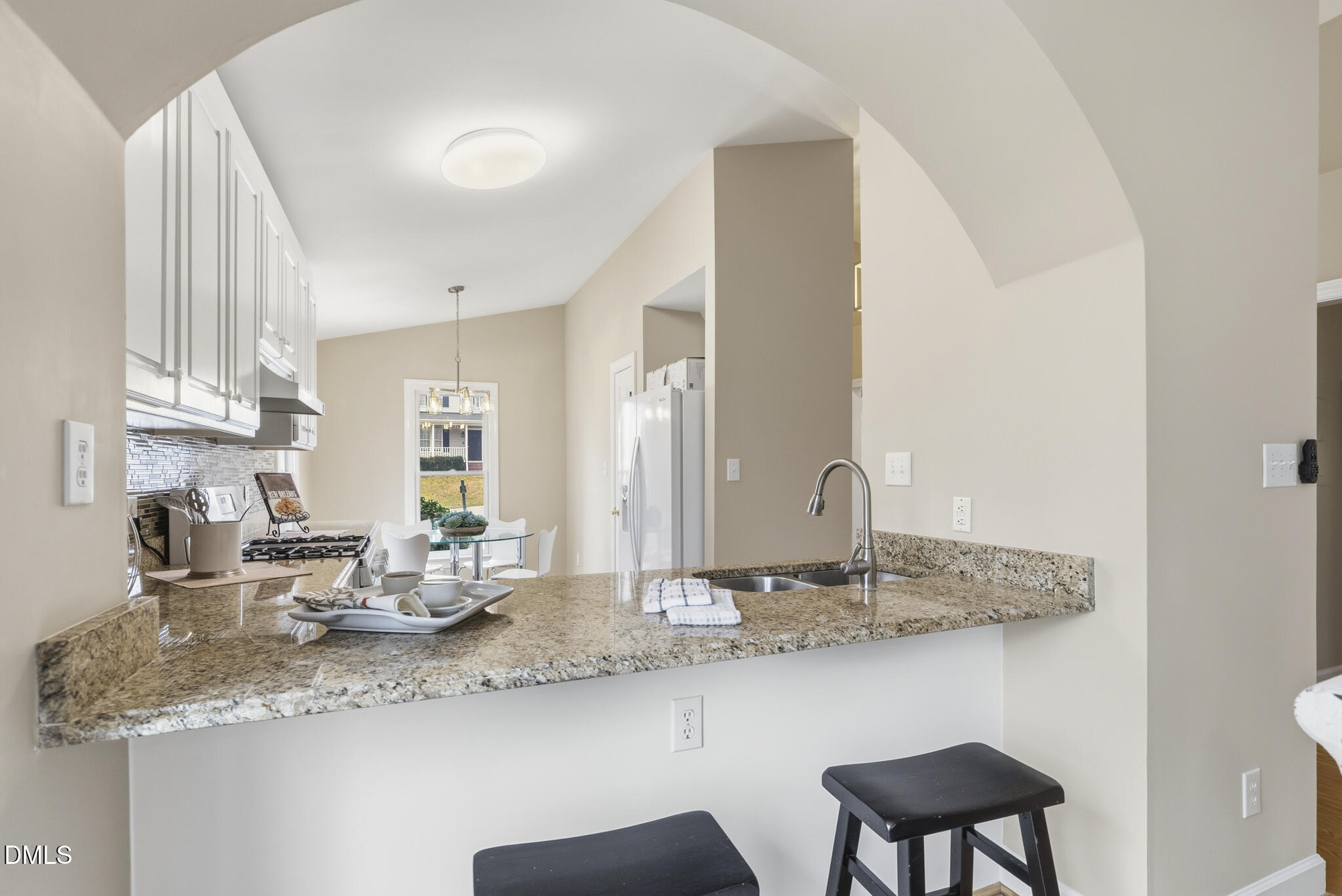 1944 Talamore Court Raleigh, NC 27604 - Photo 8 of 30 a kitchen with stainless steel appliances granite countertop a sink and a wooden cabinets