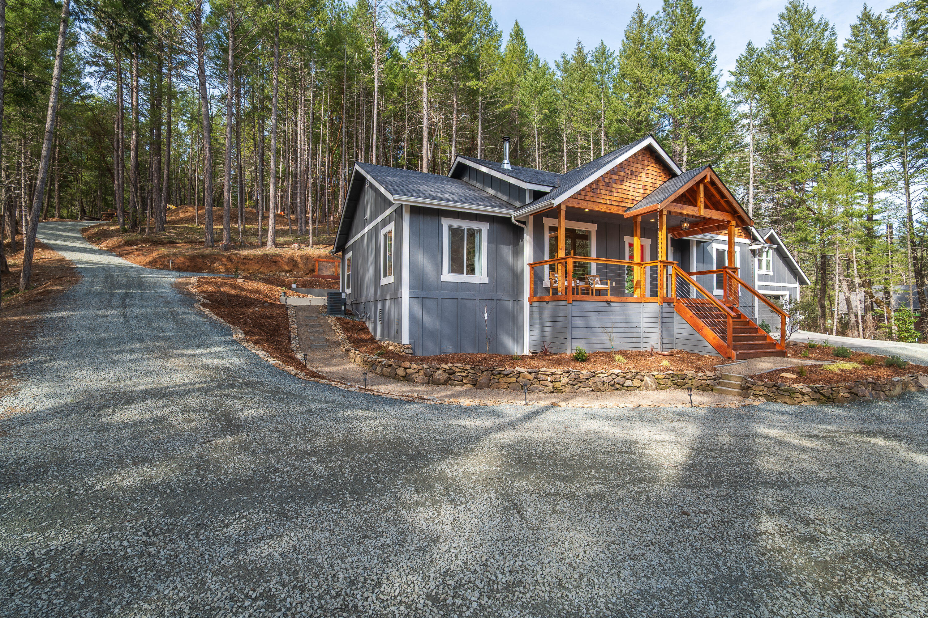 322 Round Prairie Road Wilderville, OR 97543 - Photo 51 of 55 side of home, driveway goes up to the rv parking area and fire pit, also a clearing to put potential shop ect