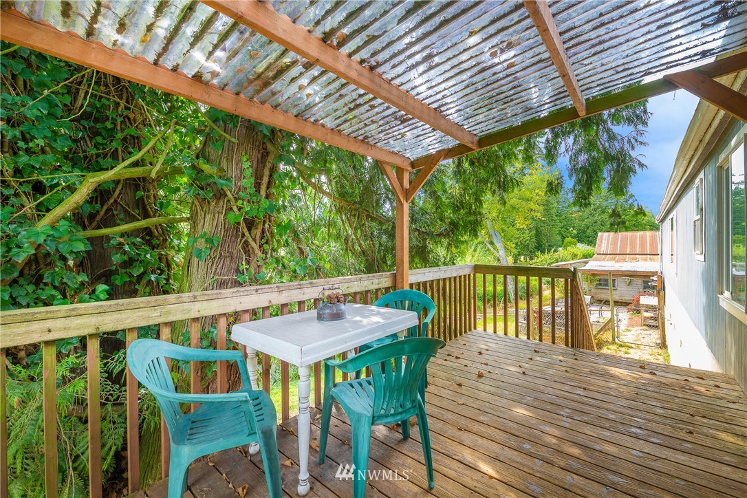 1735 Kaas Road Ferndale, WA 98248 - Photo 22 of 37 a view of a balcony with wooden floor and outdoor seating