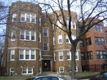 1408 West Warner Avenue, Unit 3W Chicago, IL 60613 - Photo 1 of 12 a front view of a residential apartment building with a yard