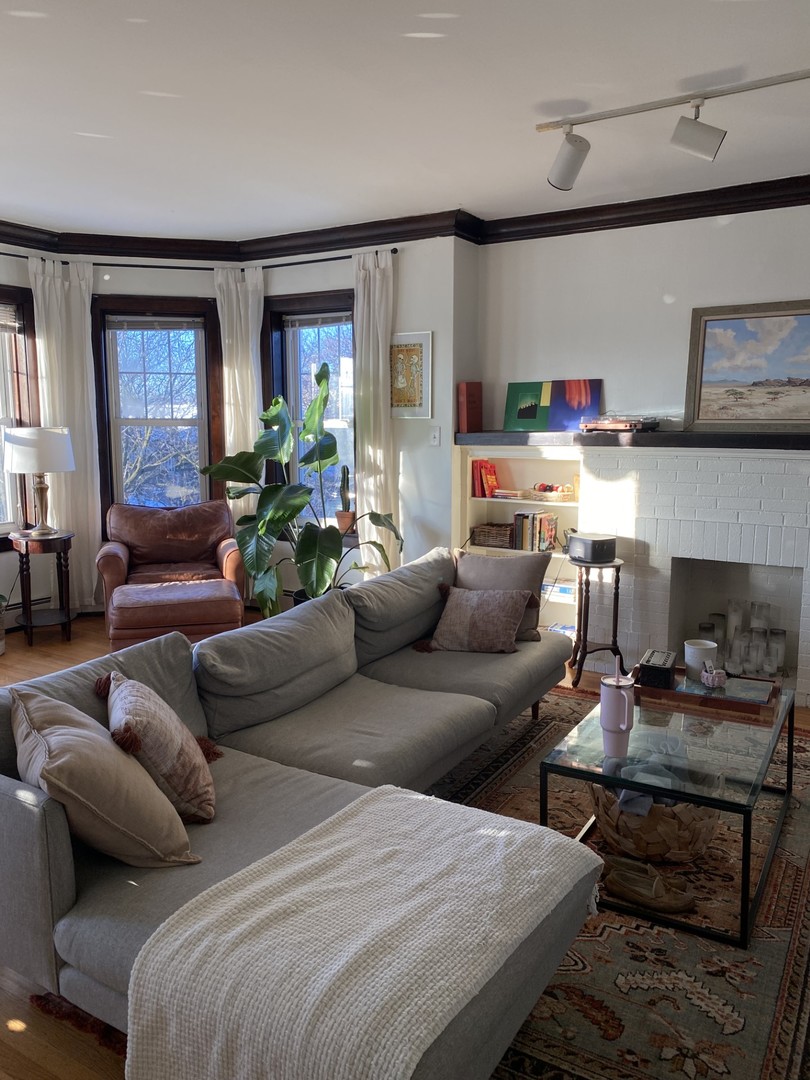1408 West Warner Avenue, Unit 3W Chicago, IL 60613 - Photo 9 of 12 a living room with furniture and a fireplace