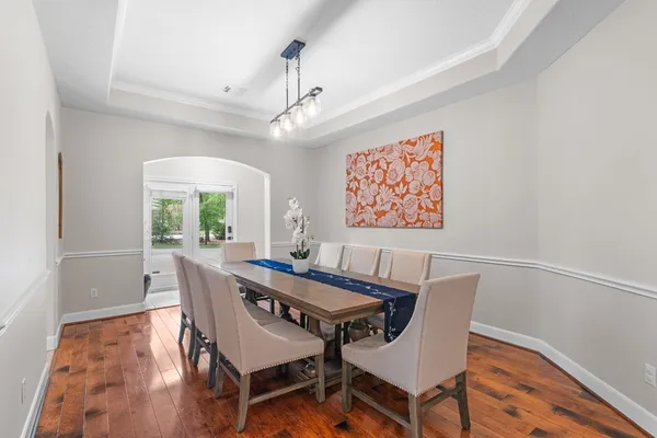 a kitchen with kitchen island granite countertop a sink stove and view of living room