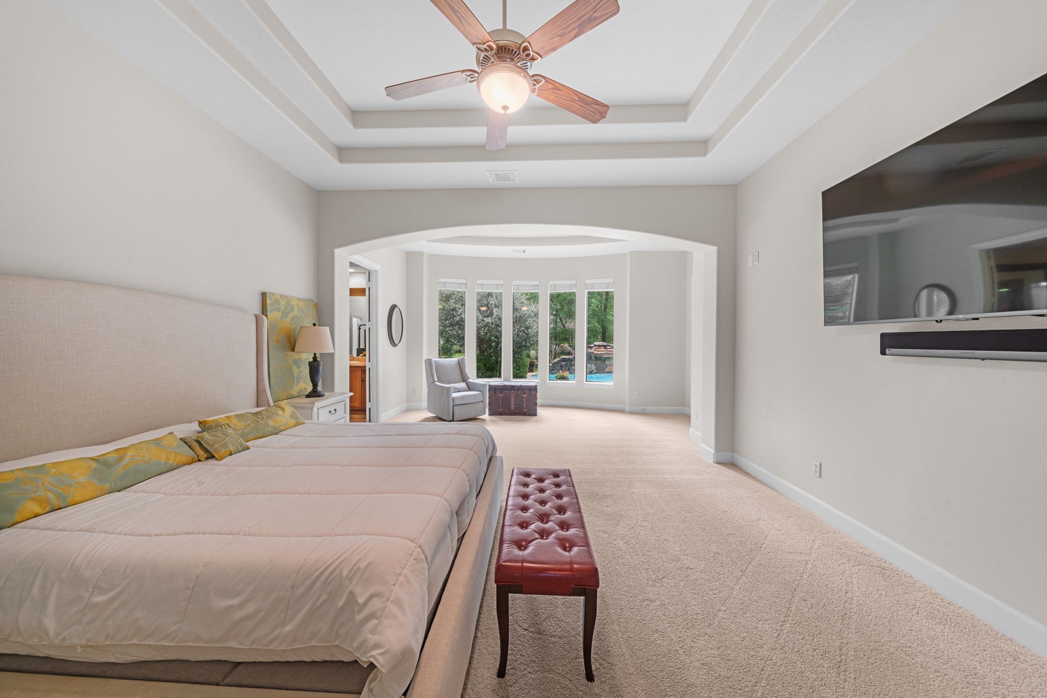 3922 Waterbend Cove Spring, TX 77386 - Photo 17 of 42 Spacious primary bedrooms with a sitting area overlooking the backyard and an en-suite bathroom.