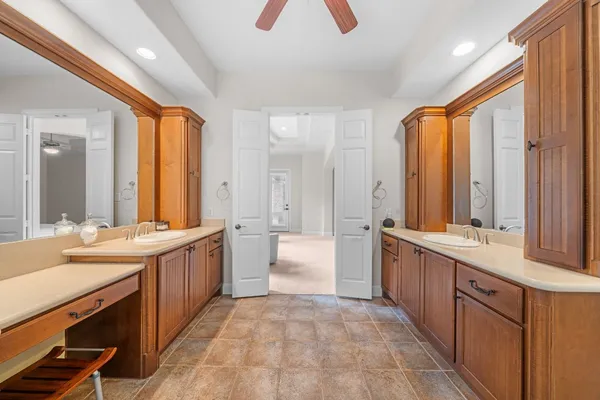 a bathroom with a sink a toilet and a mirror