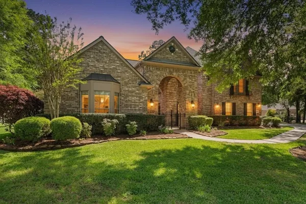 a front view of a house with a yard and outdoor seating