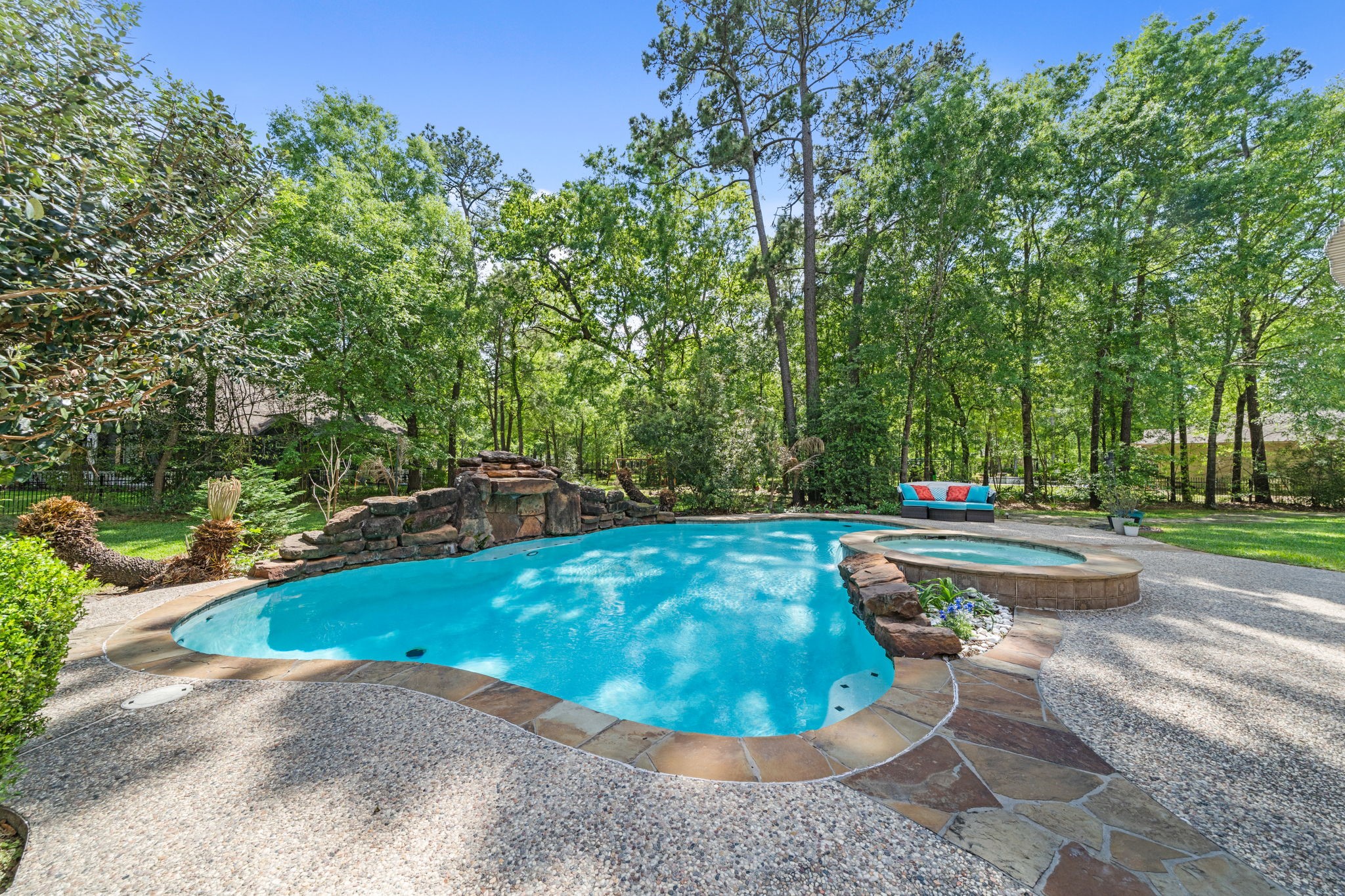 3922 Waterbend Cove Spring, TX 77386 - Photo 32 of 42 Backyard oasis with a pool, mature trees, and a covered patio! Perfect for entertaining or relaxing.