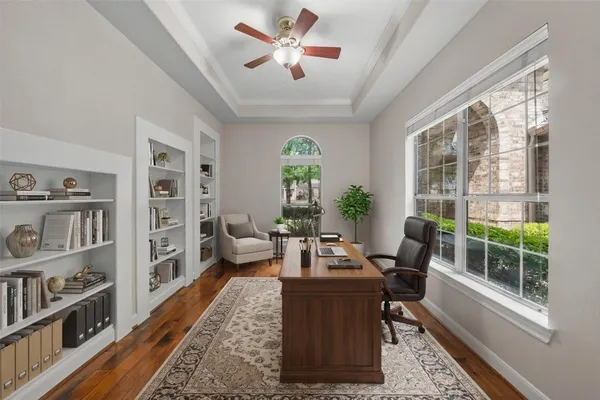 a living room with furniture large window and book shelf