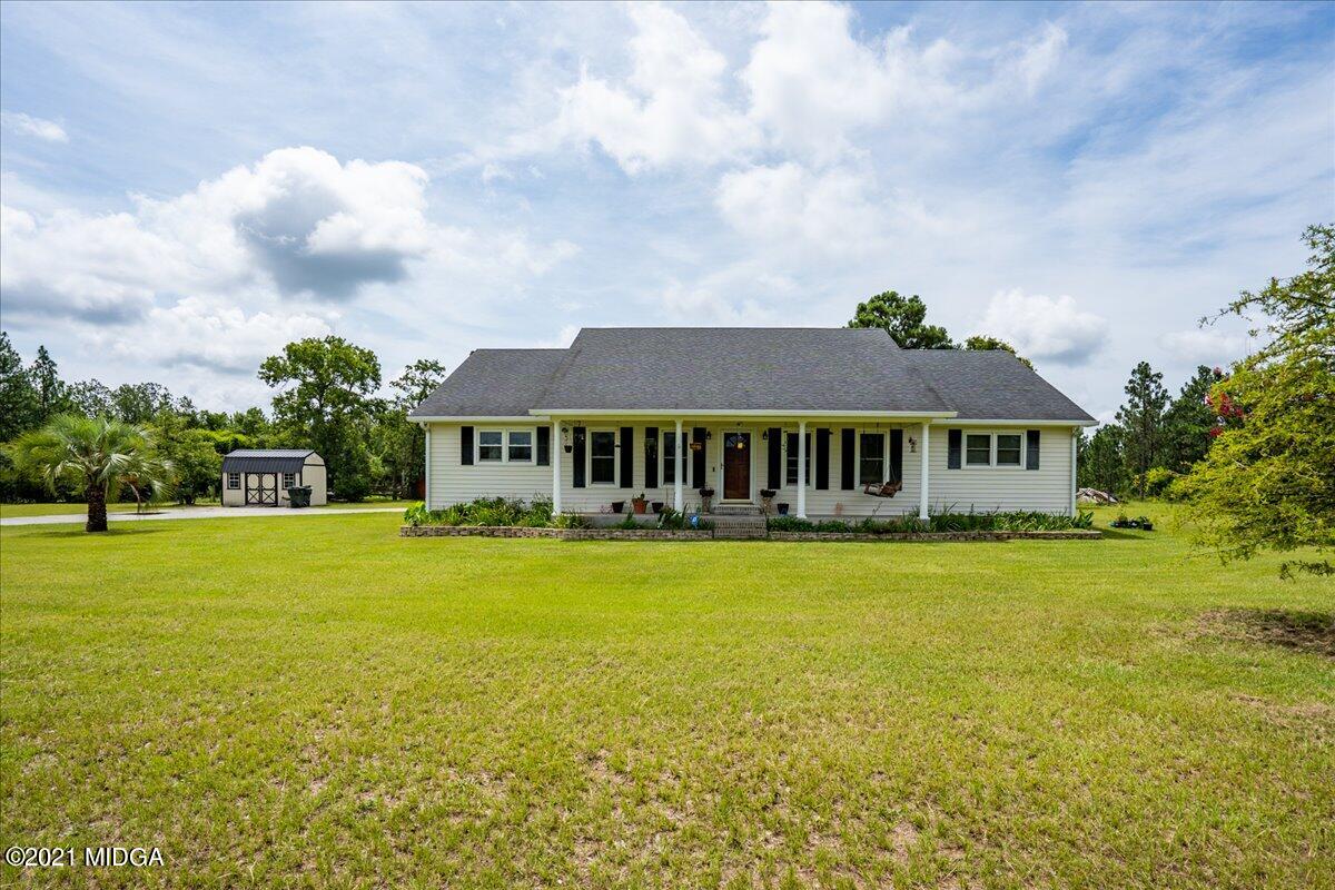 2696 Lower Hartley Bridge Road Byron, GA 31008 - Photo 1 of 24 a front view of a house with a garden