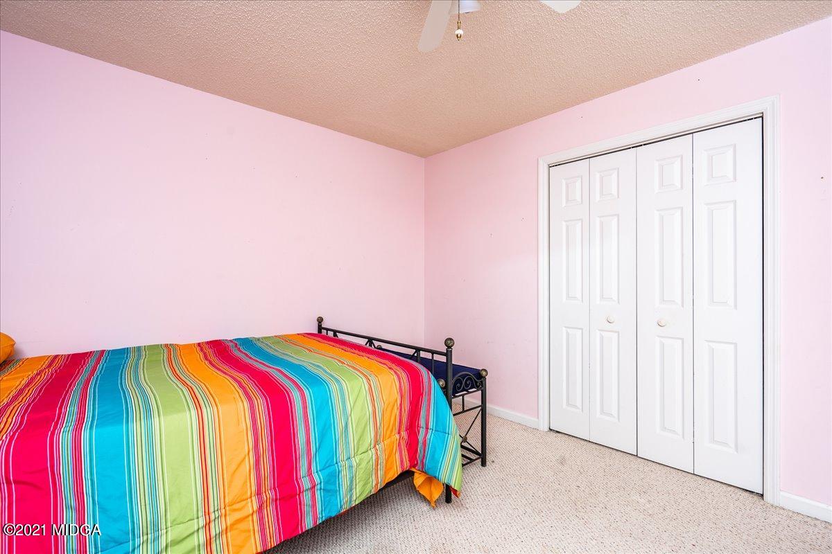 2696 Lower Hartley Bridge Road Byron, GA 31008 - Photo 12 of 24 a bedroom with a bed and a painting on the wall