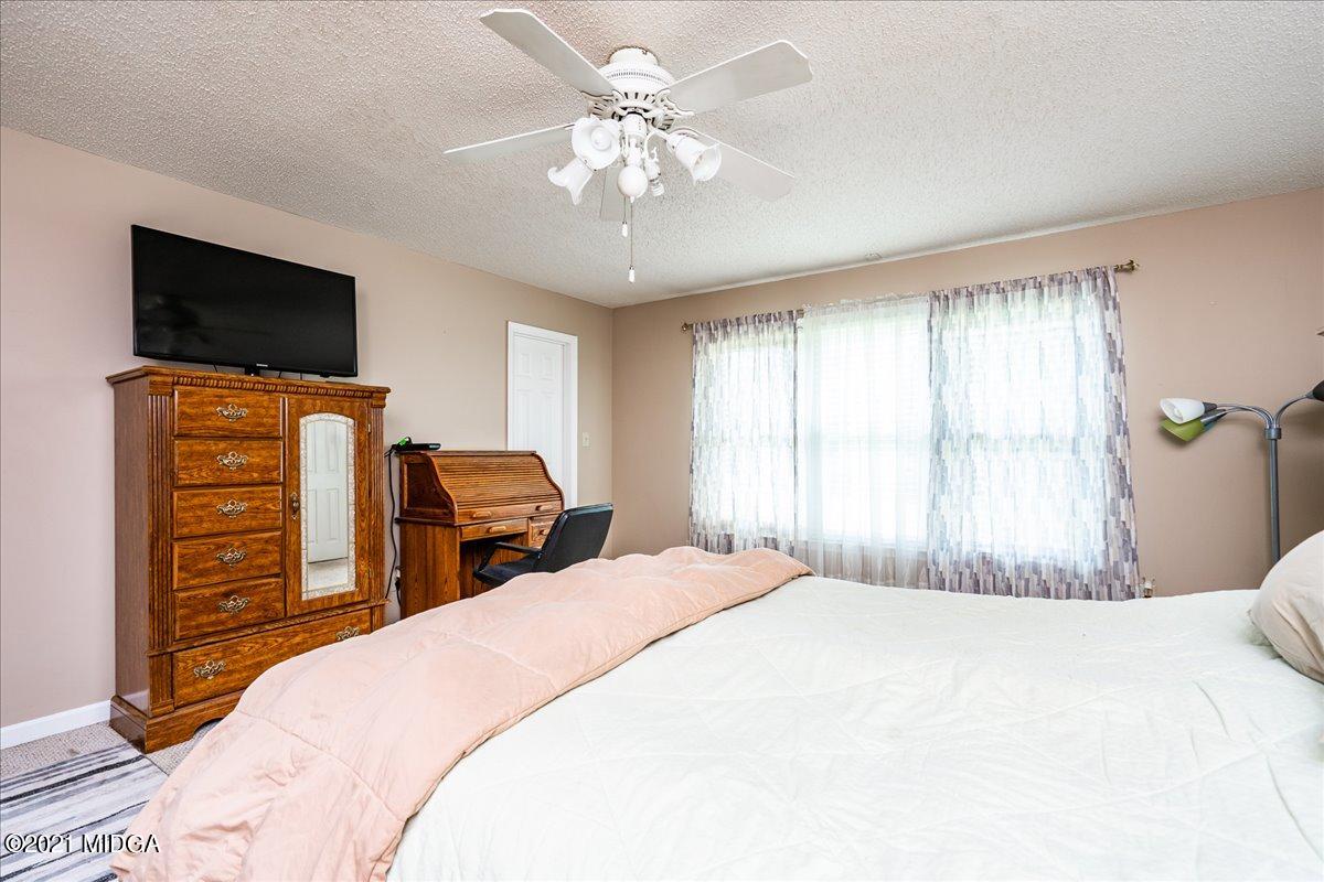 2696 Lower Hartley Bridge Road Byron, GA 31008 - Photo 14 of 24 a bedroom with a bed and a television