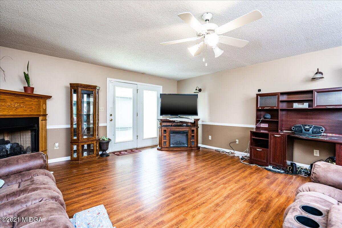 2696 Lower Hartley Bridge Road Byron, GA 31008 - Photo 19 of 24 a living room with furniture and a fireplace