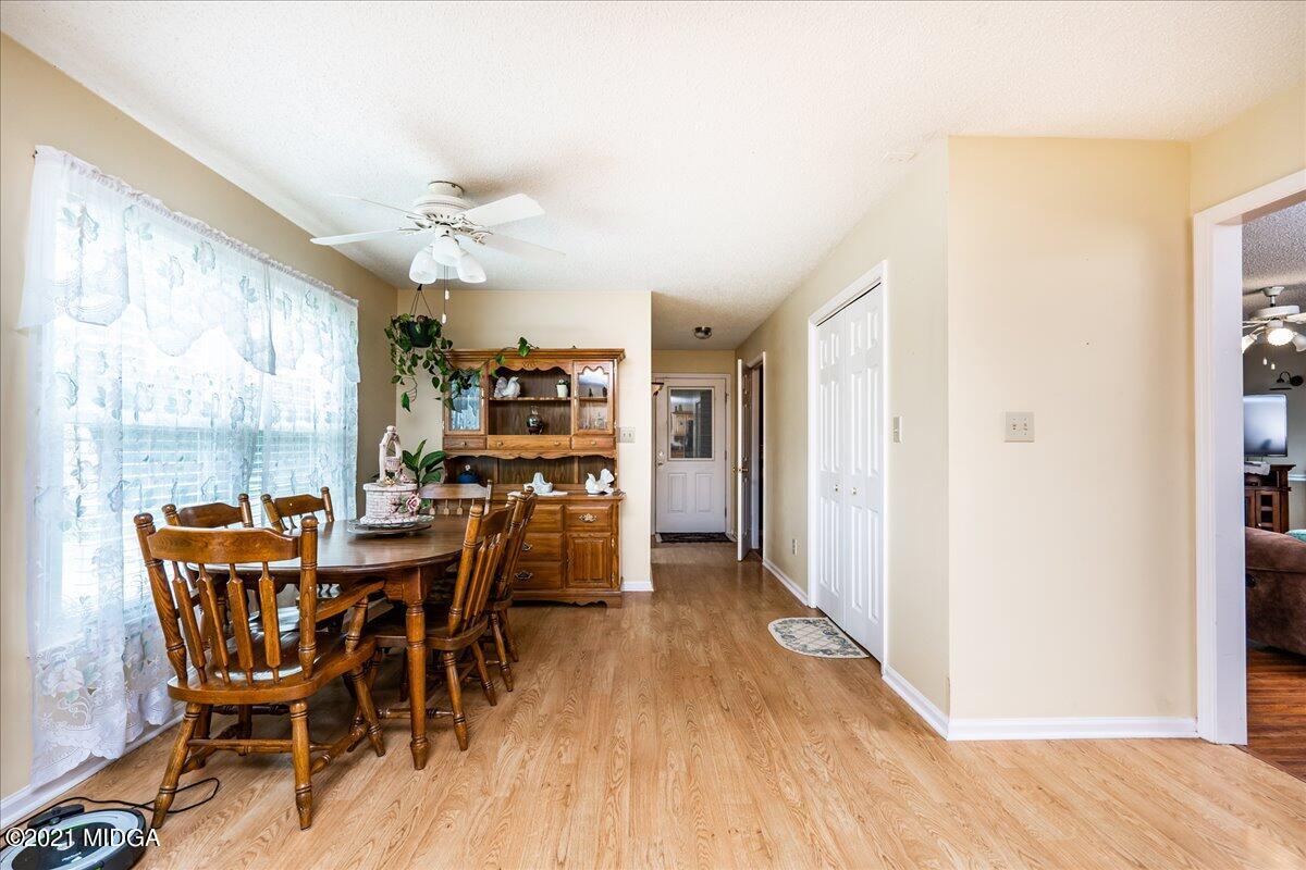 2696 Lower Hartley Bridge Road Byron, GA 31008 - Photo 22 of 24 a view of a dining room with furniture window and wooden floor