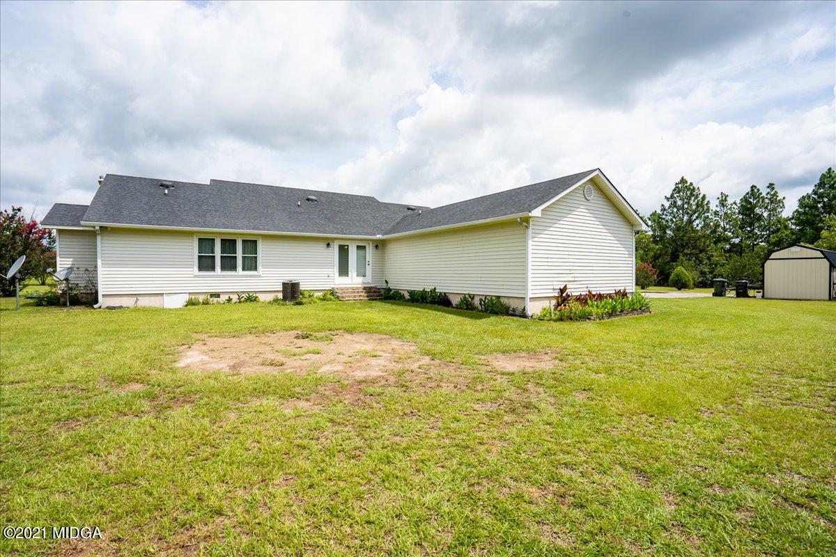 2696 Lower Hartley Bridge Road Byron, GA 31008 - Photo 5 of 24 a front view of house with yard and trees in the background