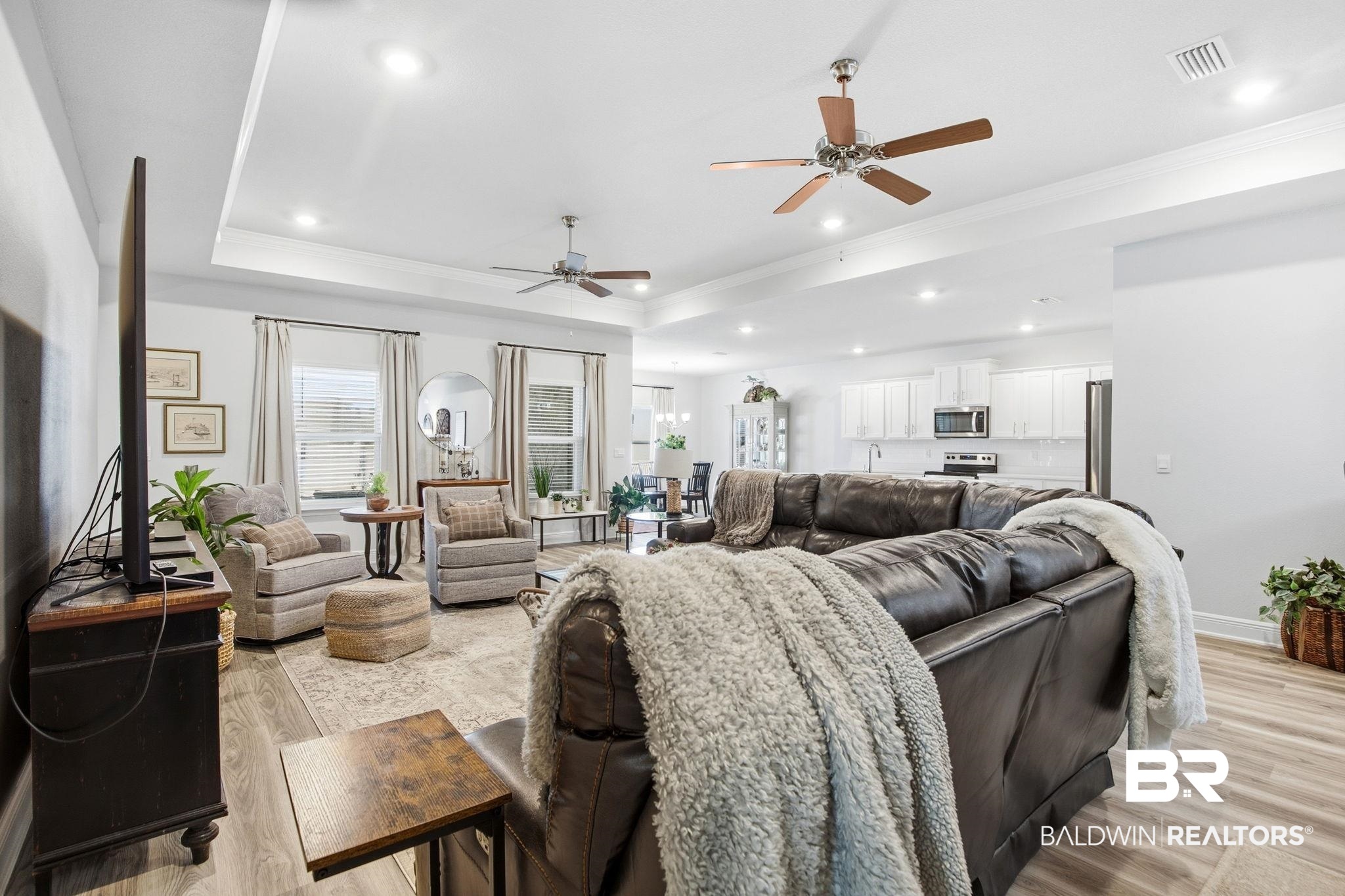 11123 Genuine Risk Circle Daphne, AL 36526 - Photo 14 of 67 Living area featuring a ceiling fan, light wood finished floors, ornamental molding, recessed lighting, and a tray ceiling