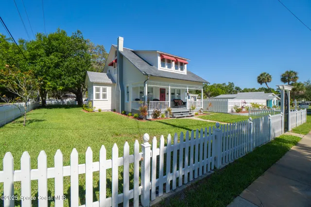 a view of a house with swimming pool and sitting area