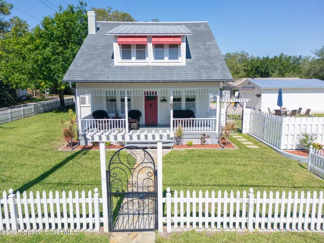 a view of a house with backyard porch and sitting area