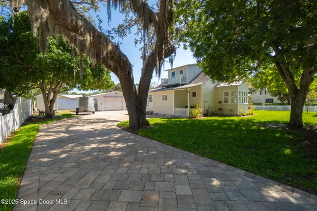 a view of a dining room with furniture wooden floor and chandelier