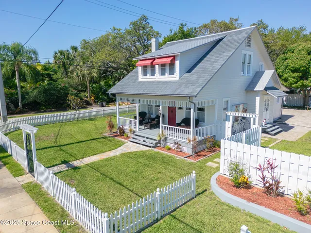 a view of a patio with couches table and chairs and potted plants