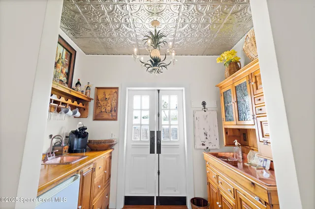 a bedroom with a bed and potted plant with the dresser