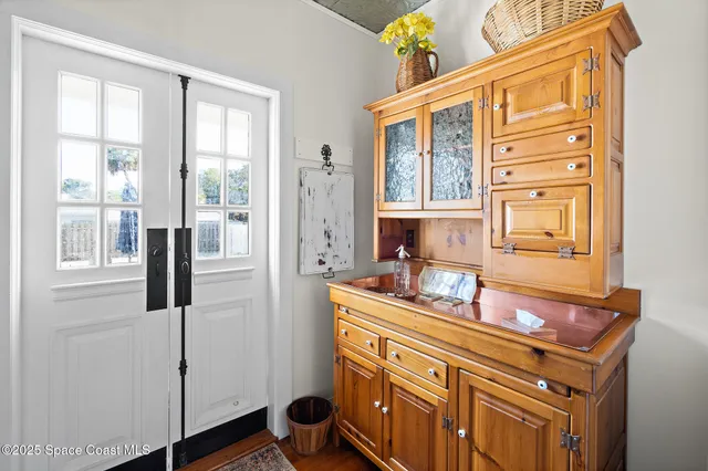 a view of a dining room with furniture a rug and wooden floor