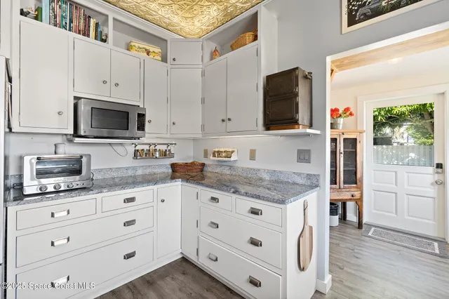 an aerial view of a house with a garden and trees