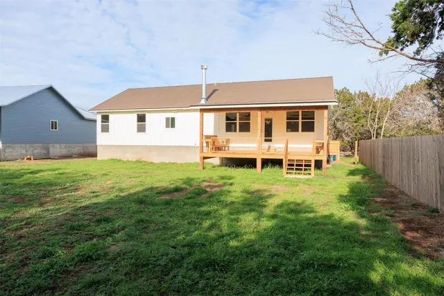 a front view of a house with a yard table and chairs