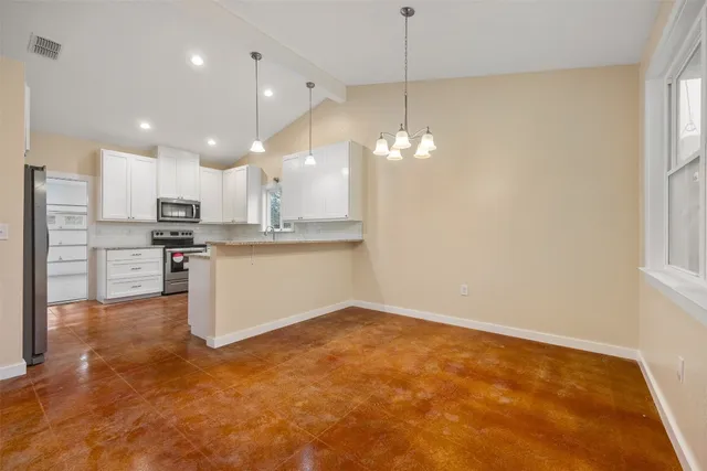 a view of a kitchen with a sink and cabinets