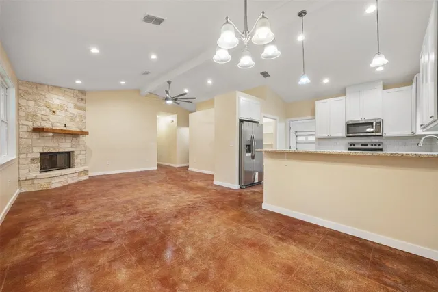 a view of a kitchen with a sink and a refrigerator