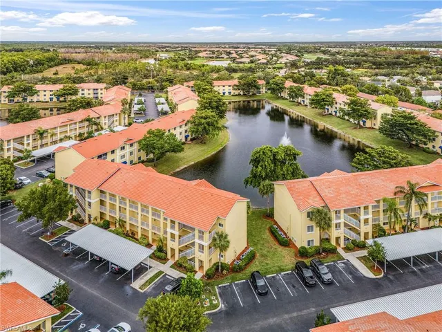 an aerial view of residential houses with outdoor space and lake view