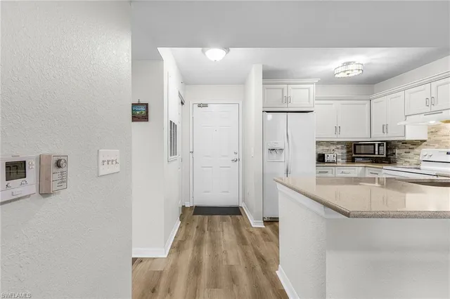 a kitchen with stainless steel appliances granite countertop a refrigerator and a sink