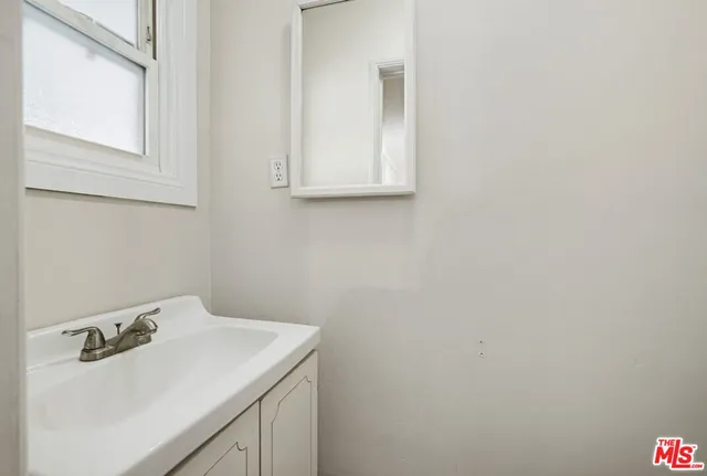 a bedroom with a bed and wall painting