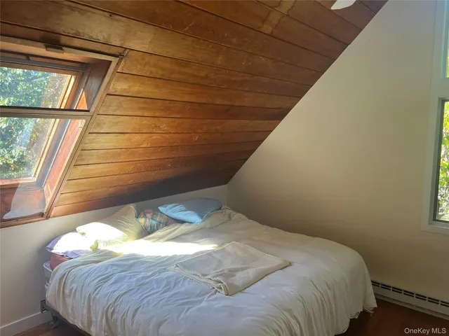 a bed sitting in a bedroom next to a window