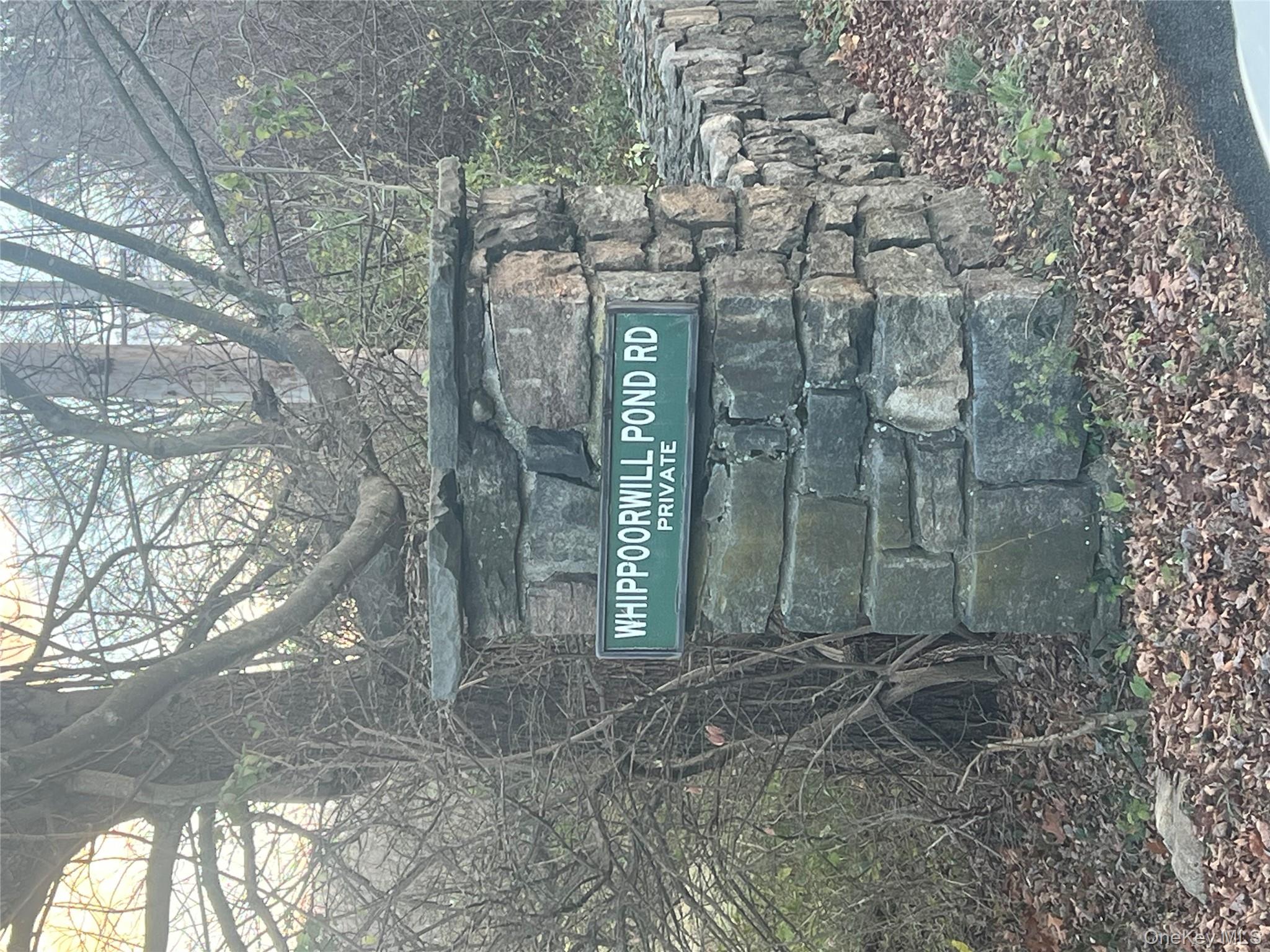 76 Whippoorwill Pond Road, Unit 78 Garrison, NY 10524 - Photo 17 of 24 a view of a wooden door and trees