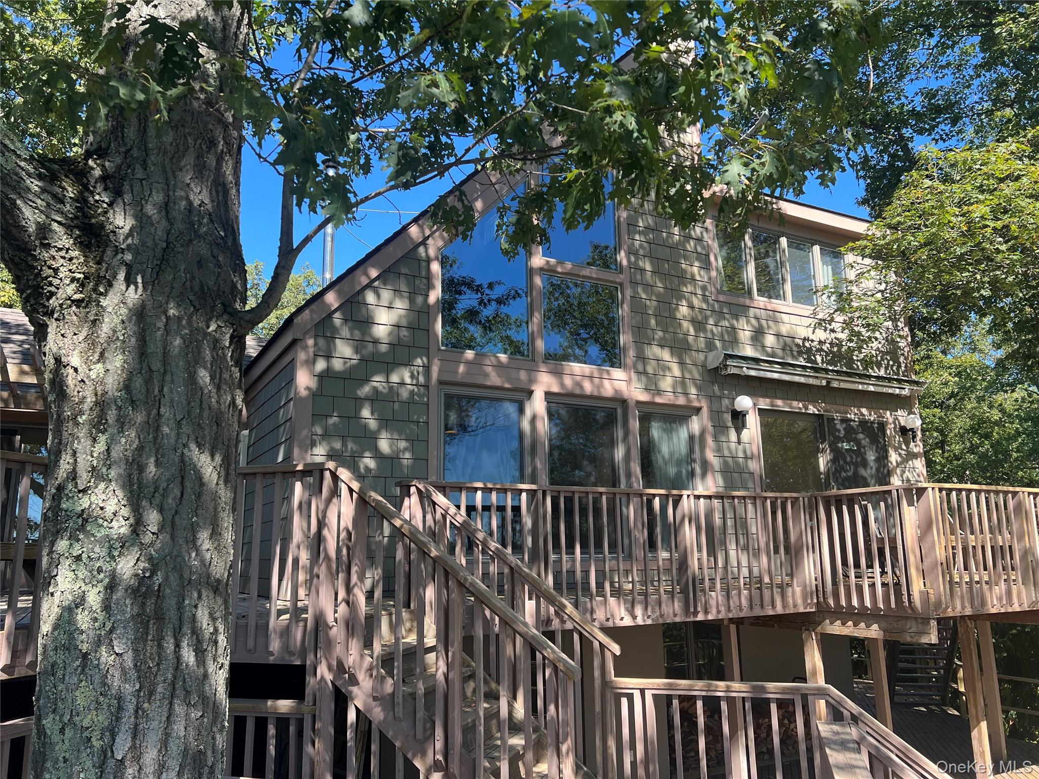 76 Whippoorwill Pond Road, Unit 78 Garrison, NY 10524 - Photo 2 of 24 a view of a house with a tree