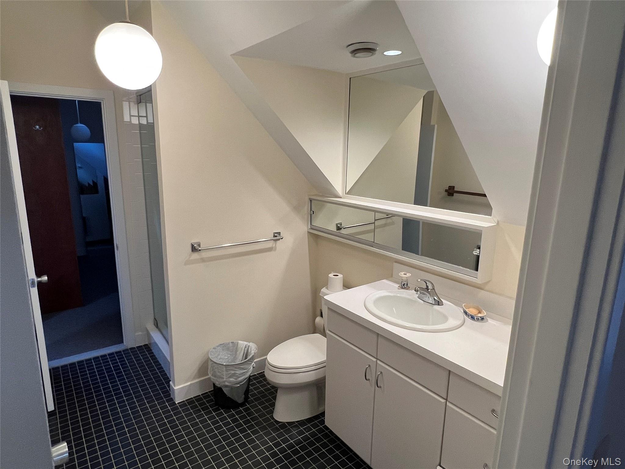 76 Whippoorwill Pond Road, Unit 78 Garrison, NY 10524 - Photo 24 of 24 a bathroom with a granite countertop sink toilet a mirror and vanity