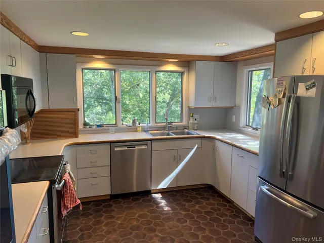 a kitchen with a refrigerator and a sink