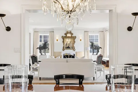 a living room with furniture and a chandelier