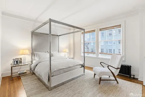 a bedroom with a bed a table and chair