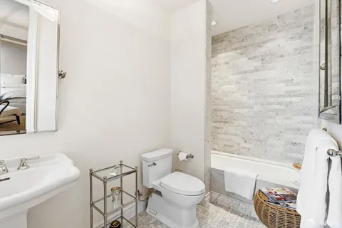 a bathroom with a sink toilet and shower