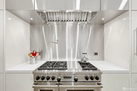 a stove top oven sitting inside of a kitchen