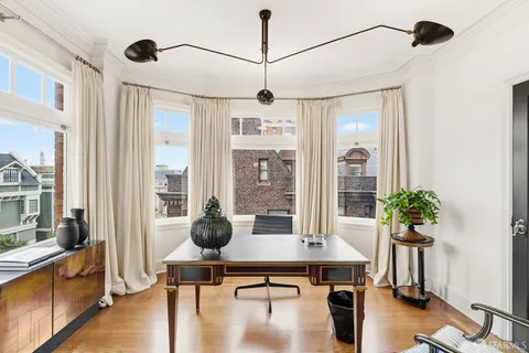 a living room with furniture and wooden floor