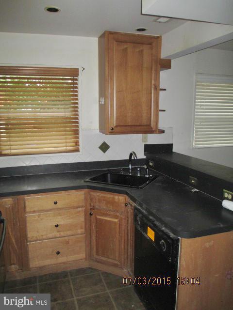 12704 Flack Street Silver Spring, MD 20906 - Photo 5 of 14 a kitchen with a sink and cabinets