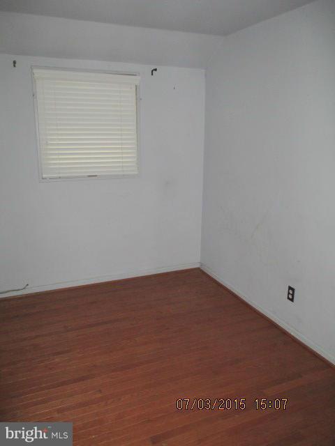 12704 Flack Street Silver Spring, MD 20906 - Photo 10 of 14 a view of an empty room with wooden floor and a window